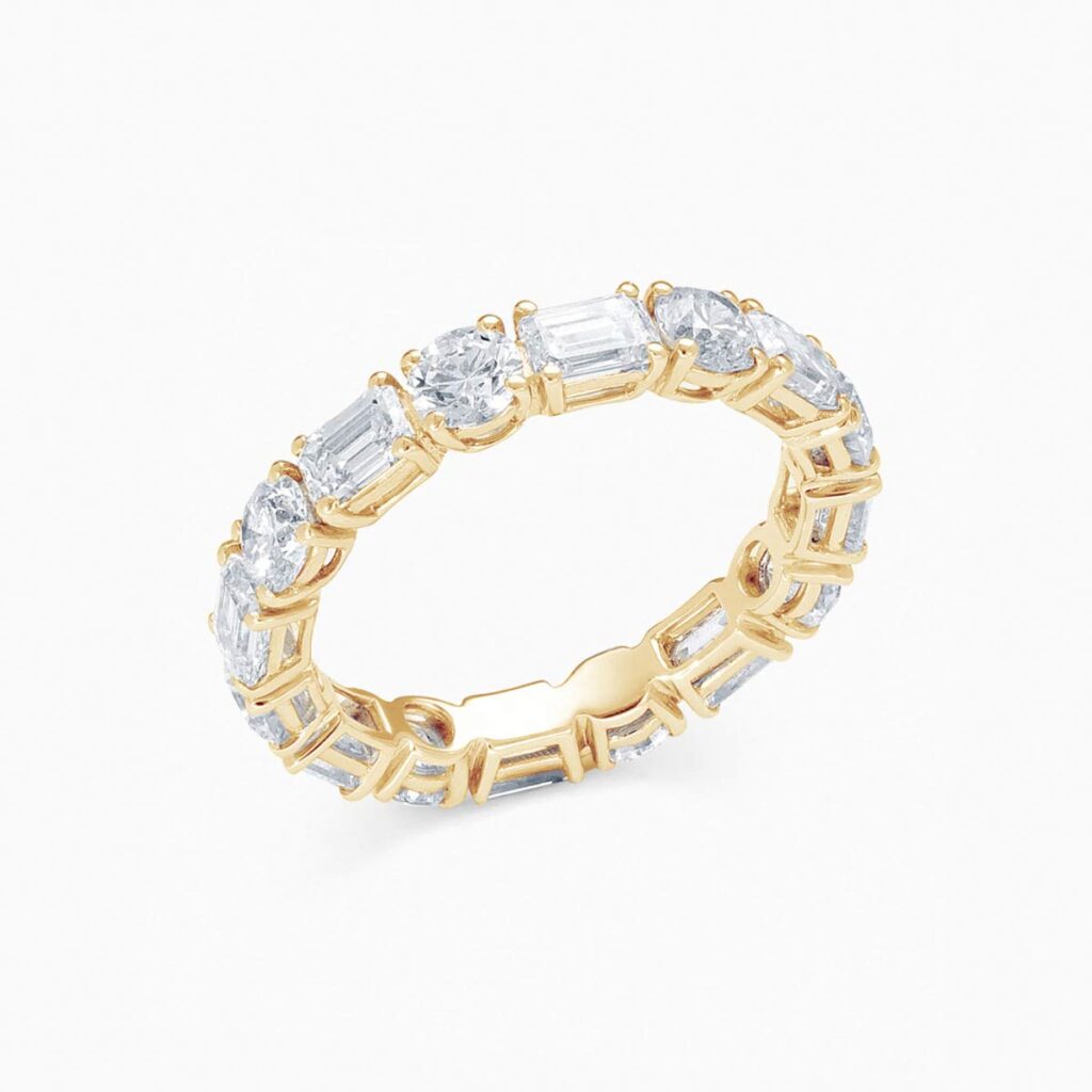 Anillo rivière Magnific en oro 18K con diamantes talla esmeralda y brillante